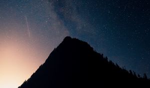 Preview wallpaper mountain, peak, silhouette, starfall, stars, night