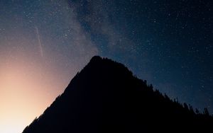 Preview wallpaper mountain, peak, silhouette, starfall, stars, night