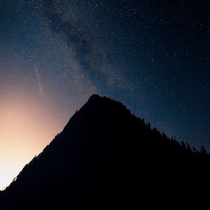 Preview wallpaper mountain, peak, silhouette, starfall, stars, night