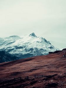 Preview wallpaper mountain, peak, snow, hut, fence