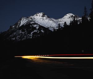 Preview wallpaper mountain, road, light, long exposure, dark