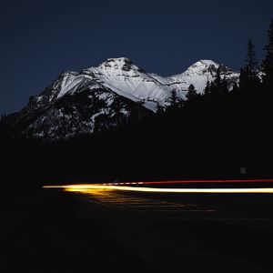 Preview wallpaper mountain, road, light, long exposure, dark