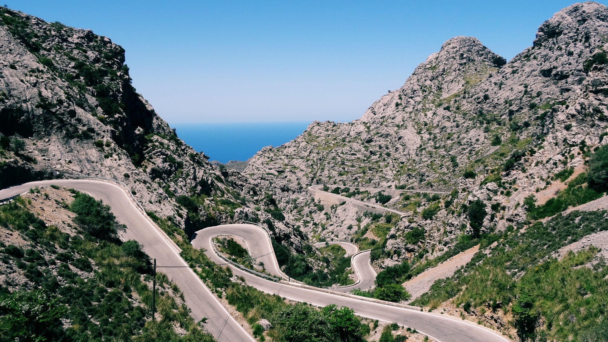 Download wallpaper 2048x1152 mountain, road, winding, grass, beautiful