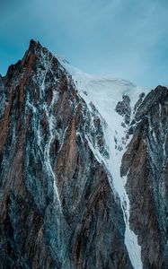 Preview wallpaper mountain, rock, cliff, peak, snow