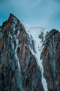Preview wallpaper mountain, rock, cliff, peak, snow
