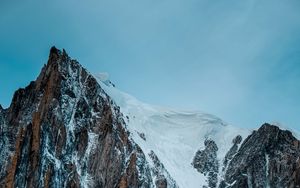 Preview wallpaper mountain, rock, cliff, peak, snow