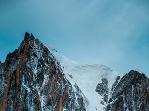 Preview wallpaper mountain, rock, cliff, peak, snow