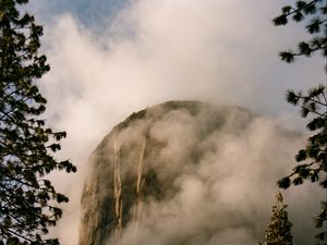 Preview wallpaper mountain, rock, clouds, trees, nature, landscape