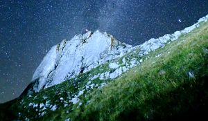 Preview wallpaper mountain, rock, slope, milky way, grass