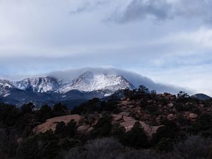 Preview wallpaper mountain, rock, stones, trees, clouds, nature