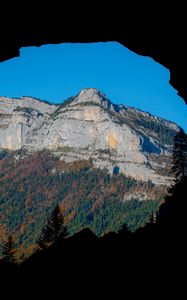 Preview wallpaper mountain, rocks, peak, cave, trees