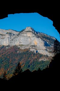 Preview wallpaper mountain, rocks, peak, cave, trees