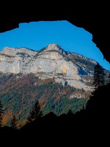 Preview wallpaper mountain, rocks, peak, cave, trees