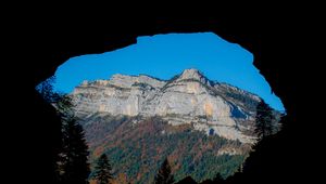 Preview wallpaper mountain, rocks, peak, cave, trees