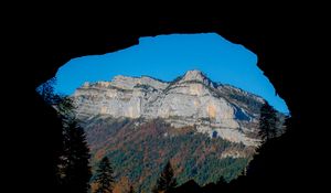 Preview wallpaper mountain, rocks, peak, cave, trees