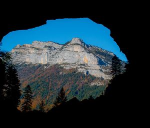 Preview wallpaper mountain, rocks, peak, cave, trees