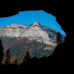 Preview wallpaper mountain, rocks, peak, cave, trees