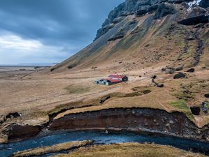 Preview wallpaper mountain, slope, house, river, nature