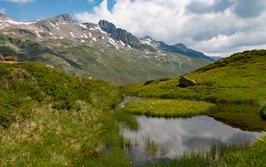 Preview wallpaper mountain, slope, pond, grass, nature