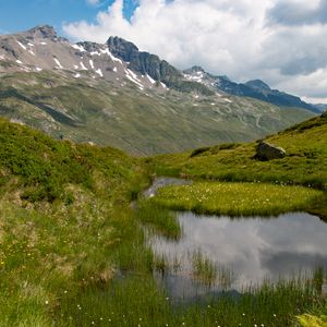 Preview wallpaper mountain, slope, pond, grass, nature