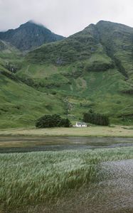 Preview wallpaper mountain, slope, river, house, grass