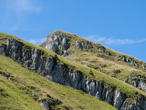 Preview wallpaper mountain, slope, rocks, grass, nature