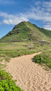Preview wallpaper mountain, slope, sand, grass, trail, sky, clouds