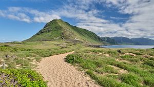 Preview wallpaper mountain, slope, sand, grass, trail, sky, clouds