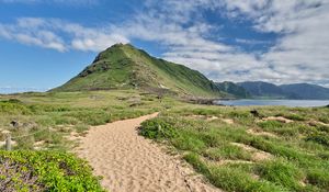 Preview wallpaper mountain, slope, sand, grass, trail, sky, clouds