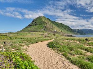 Preview wallpaper mountain, slope, sand, grass, trail, sky, clouds
