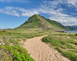 Preview wallpaper mountain, slope, sand, grass, trail, sky, clouds