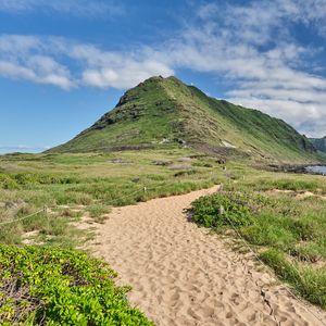 Preview wallpaper mountain, slope, sand, grass, trail, sky, clouds