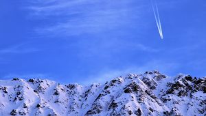 Preview wallpaper mountain, snow, plane, sky, snowy, flight, peak