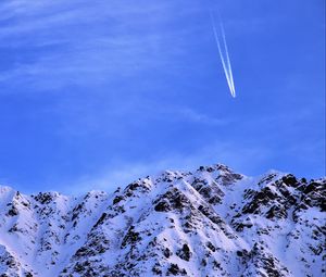 Preview wallpaper mountain, snow, plane, sky, snowy, flight, peak