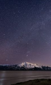 Preview wallpaper mountain, snow, sea, starry sky, night