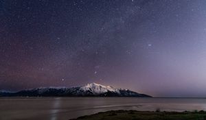Preview wallpaper mountain, snow, sea, starry sky, night