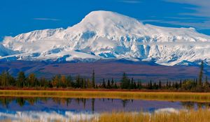 Preview wallpaper mountain, snow-covered, top, autumn, trees, lake, clouds, reflections, haze, sky, blue, harmony