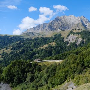 Preview wallpaper mountain, trees, house, road, nature, landscape