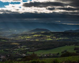 Preview wallpaper mountain, valley, clouds, overcast, village