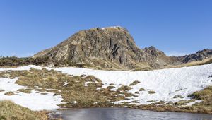 Preview wallpaper mountain, valley, snow, pond, grass