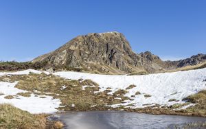 Preview wallpaper mountain, valley, snow, pond, grass