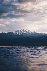 Preview wallpaper mountain, water, blur, peaks, clouds