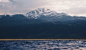 Preview wallpaper mountain, water, blur, peaks, clouds