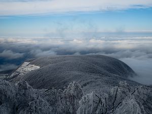 Preview wallpaper mountain, winter, clouds, frost, peak, sky