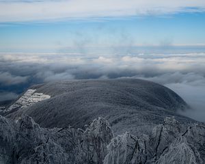 Preview wallpaper mountain, winter, clouds, frost, peak, sky