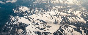 Preview wallpaper mountains, aerial view, snowy, peaks, clouds, sky