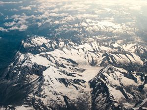 Preview wallpaper mountains, aerial view, snowy, peaks, clouds, sky