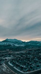 Preview wallpaper mountains, aerial view, village, snowy, sky