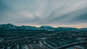 Preview wallpaper mountains, aerial view, village, snowy, sky