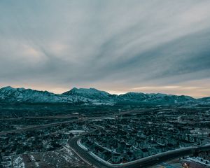 Preview wallpaper mountains, aerial view, village, snowy, sky